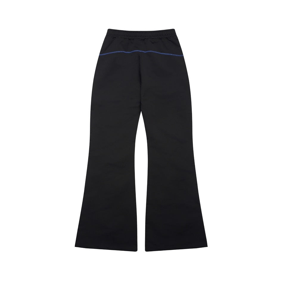 Back view of black flared pants with an elastic waistband and a blue horizontal seam across the upper seat.