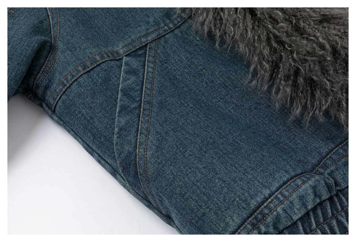 Close-up of blue denim jacket seams with gray shaggy trim along the edge.