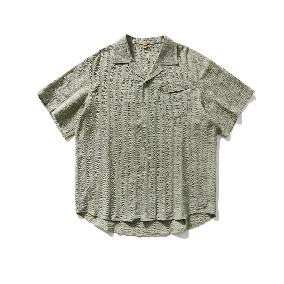 Sage green short-sleeve camp-collar shirt with textured vertical stripes, button front and chest pocket, flat lay