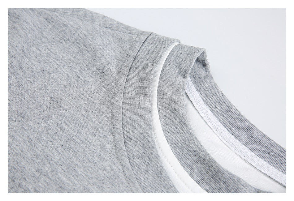 Close-up showing the gray T-shirt's shoulder seam, ribbed collar, and white inner layer.
