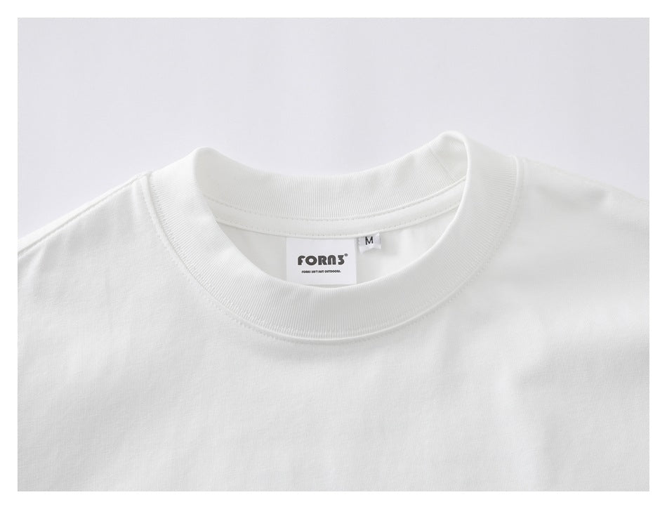 Close-up of the white T-shirt's ribbed crew neck, inner brand label, and size M tag.