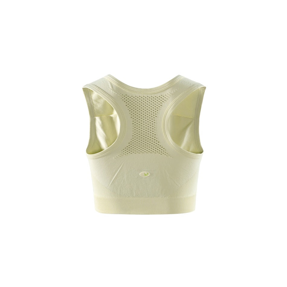 Back view of a pale yellow cropped athletic top with a racerback and perforated mesh panel.