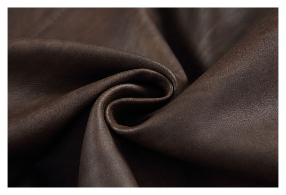 Close-up of dark brown pebbled material gathered into a curved fold.