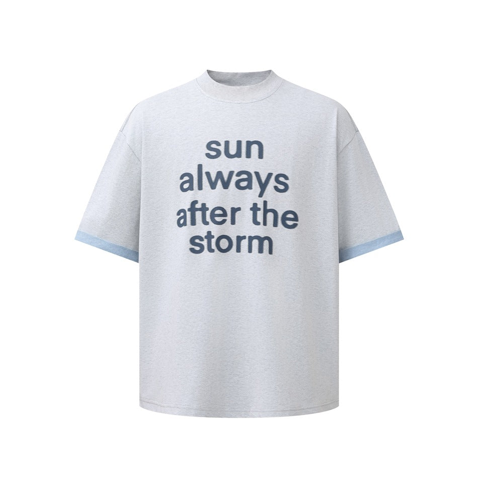 Light gray-blue short-sleeve T-shirt with 'sun always after the storm' print and light blue contrast sleeve cuffs