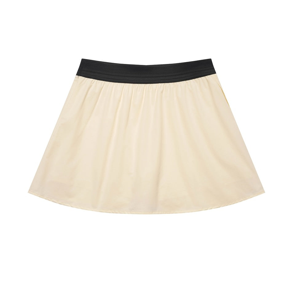 Flat-lay view of a flared ivory skirt with a wide black elastic waistband.