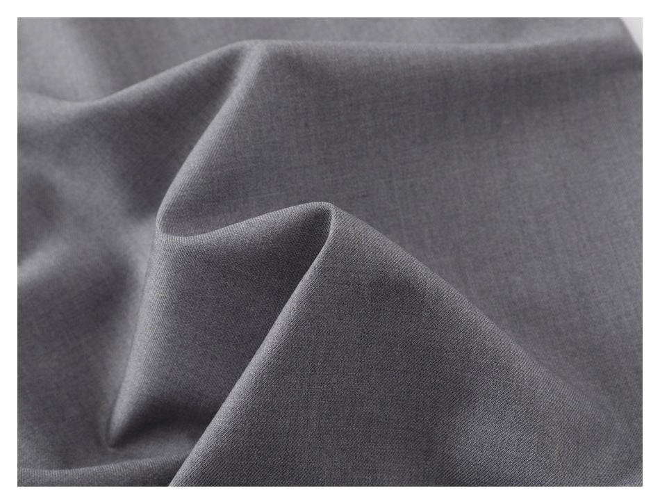 Close-up of plain charcoal gray fabric folded to show its fine knit texture.
