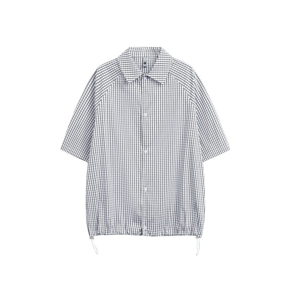 Black and white check short-sleeve button-up shirt flat lay with pointed collar and drawcord hem