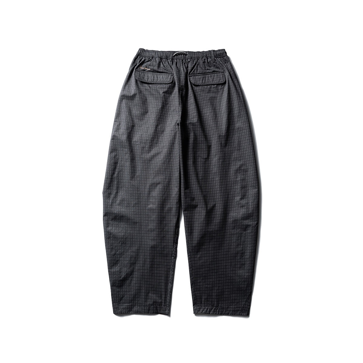 Back view of black fine-plaid loose pants with an elastic drawstring waist and two flap pockets.