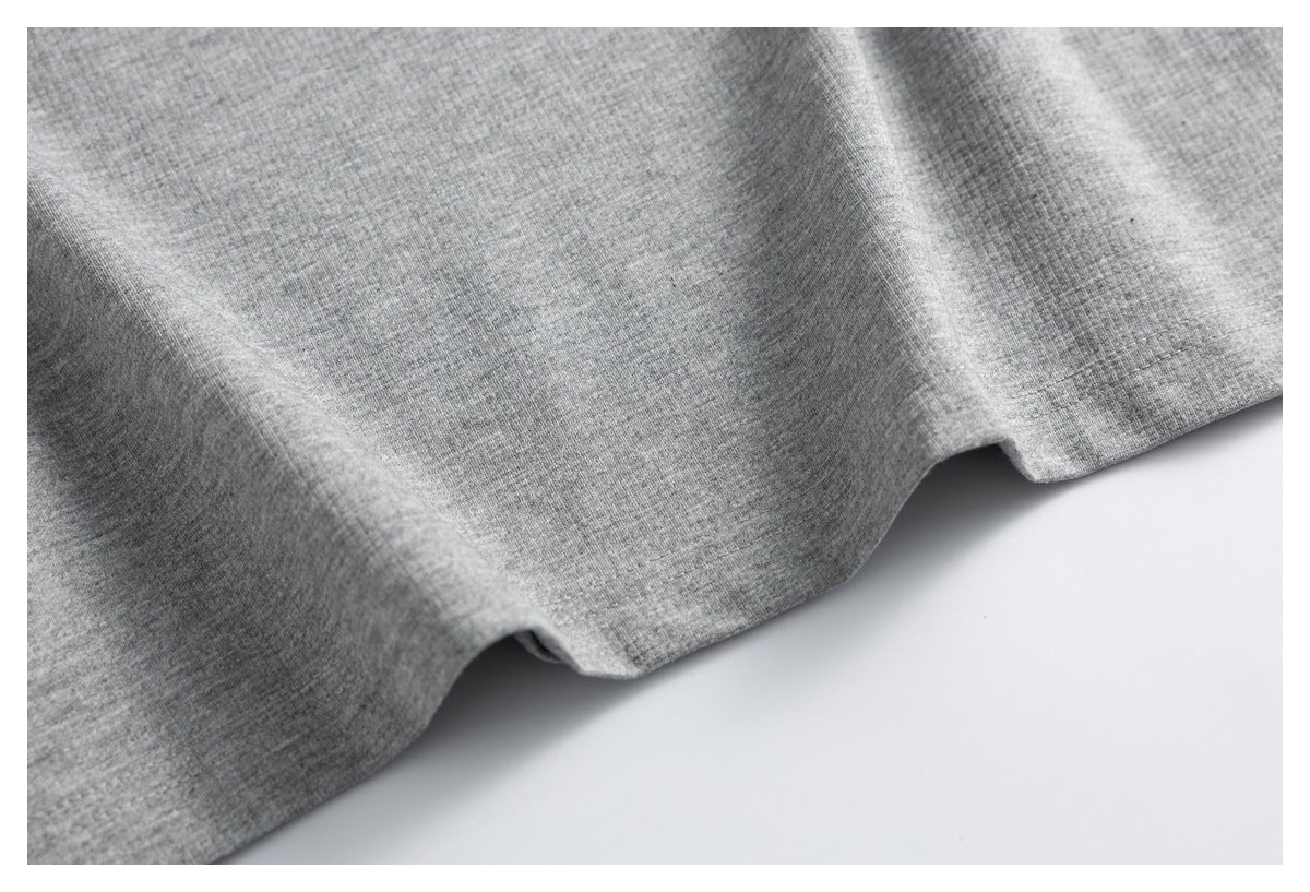 Close-up of the finished hem on heather gray fabric.