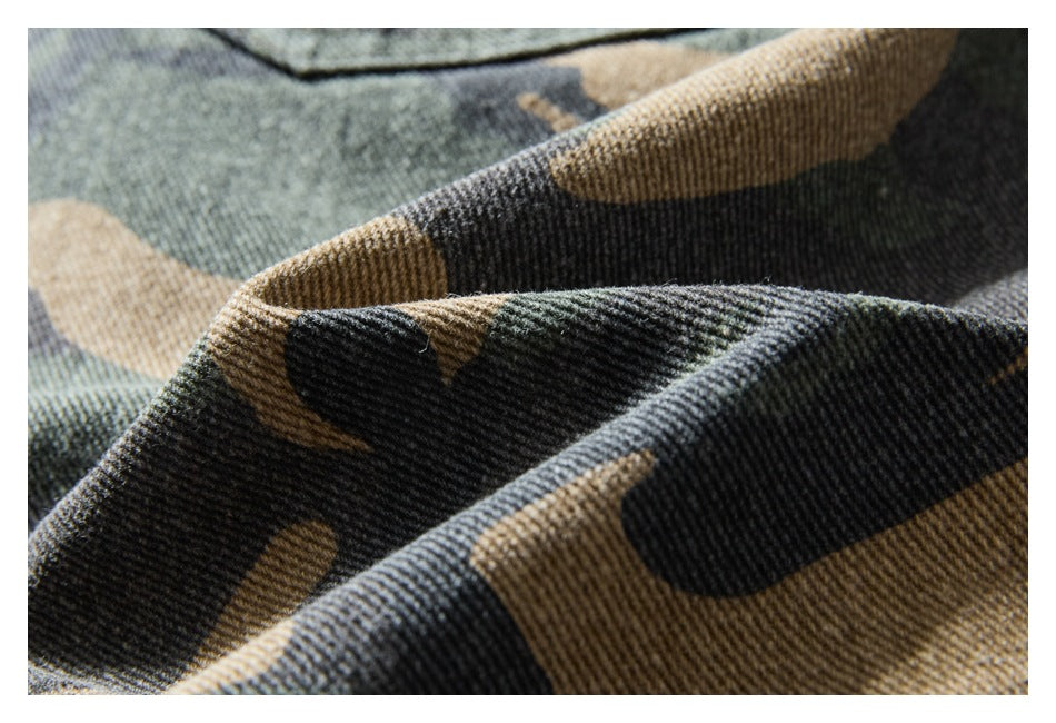 Macro view of the textured woven camouflage fabric in muted green, tan, and charcoal.