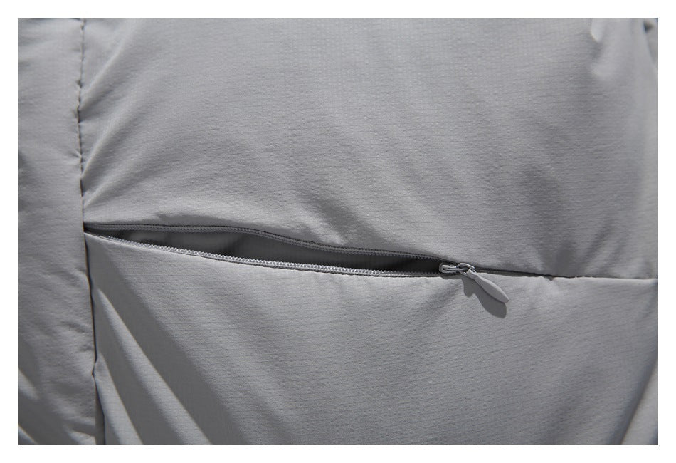 Close-up of a horizontal zip pocket on the light gray jacket.