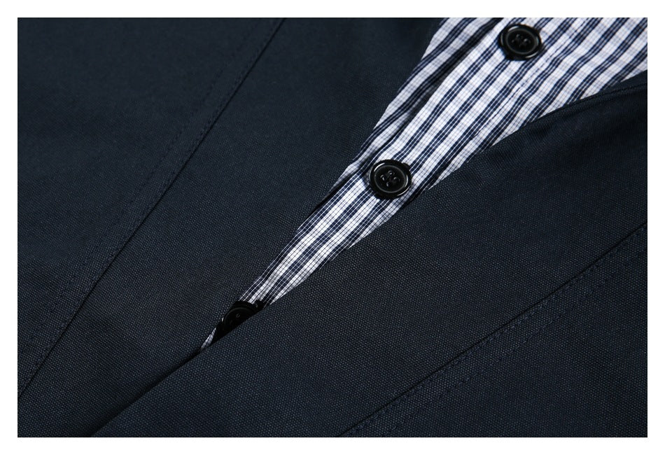 Close-up of black buttons and checked placket framed by dark navy jacket fabric.