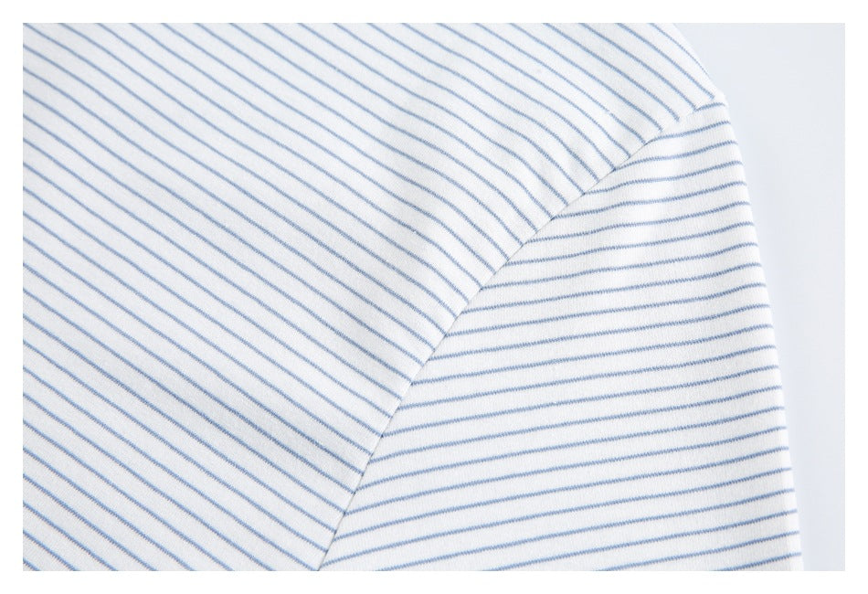 Close-up of the striped shirt's sleeve seam and hem, with blue stripes running in different directions.