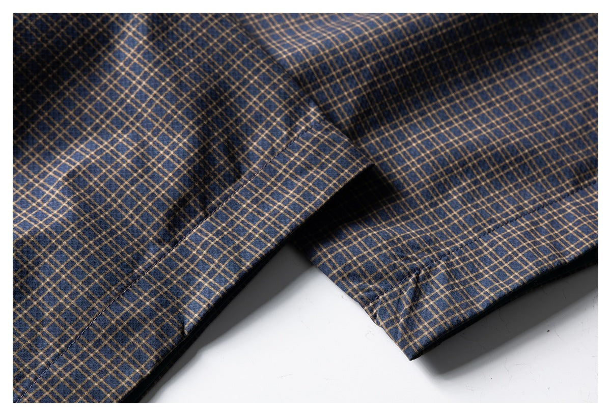 Close-up of navy plaid garment panels and stitched edges.
