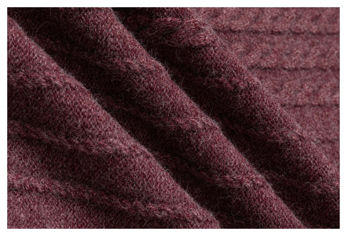 Macro view of the fuzzy yarn and knit texture of a burgundy garment.