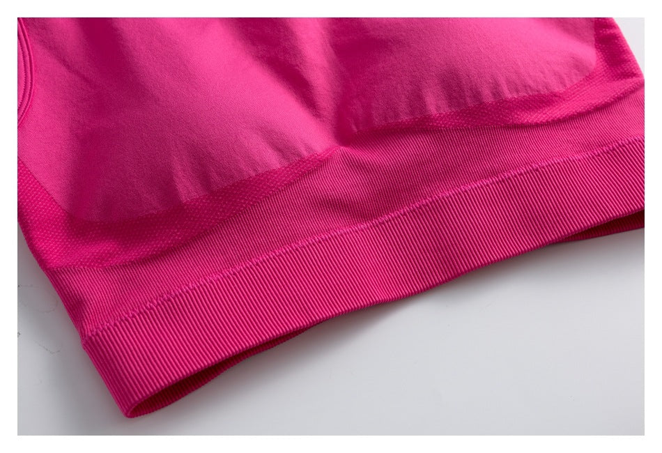 Close-up of the pink athletic top's wide ribbed hem and stitched lower edge.