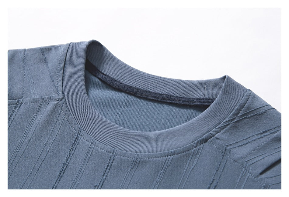 Close-up of the blue T-shirt's ribbed crew neck and textured vertical stripe pattern.