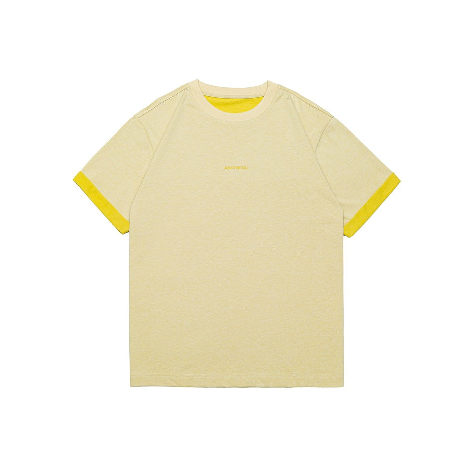 Light apricot-yellow short-sleeve crew neck T-shirt with bright yellow contrast cuffs and neckline, small chest lettering