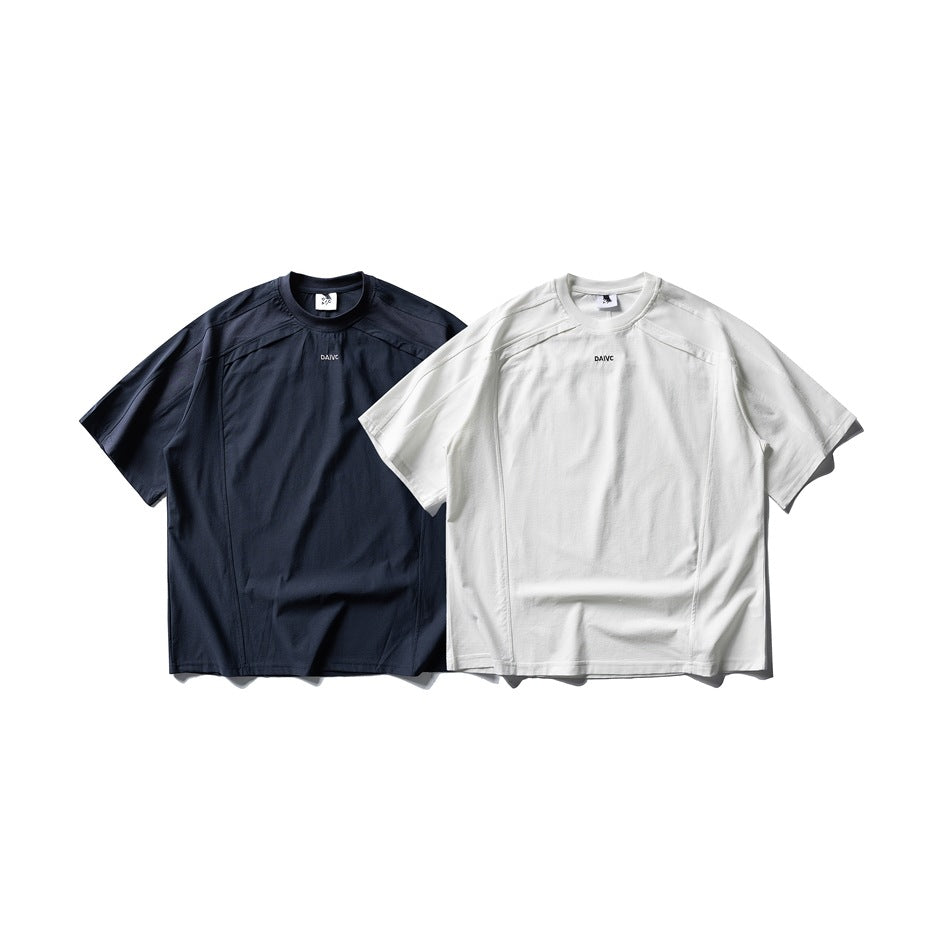 Two short-sleeve crew-neck shirts shown from the front in navy and white, with seam panels and small chest lettering.