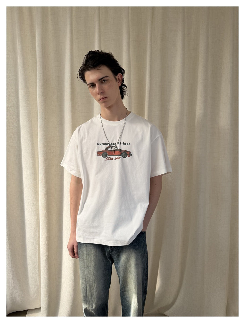 Front view of a model wearing a white graphic T-shirt with a red car and English text on the chest.