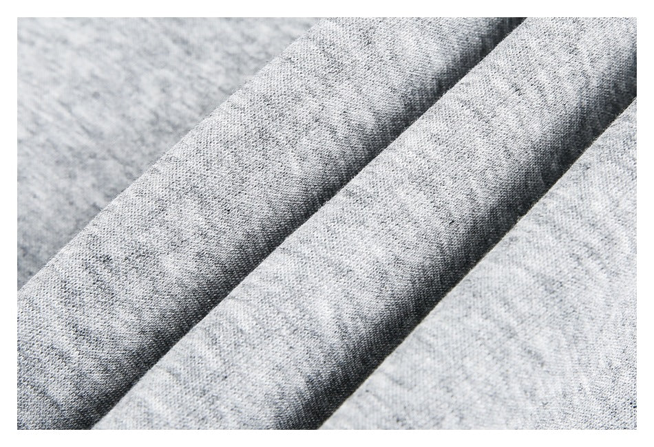 Extreme close-up of heather gray knit fabric gathered into soft folds.