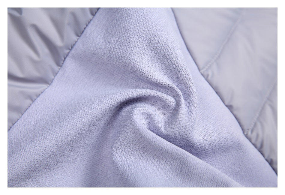 Close-up of soft-looking light gray knit fabric beside quilted panels.