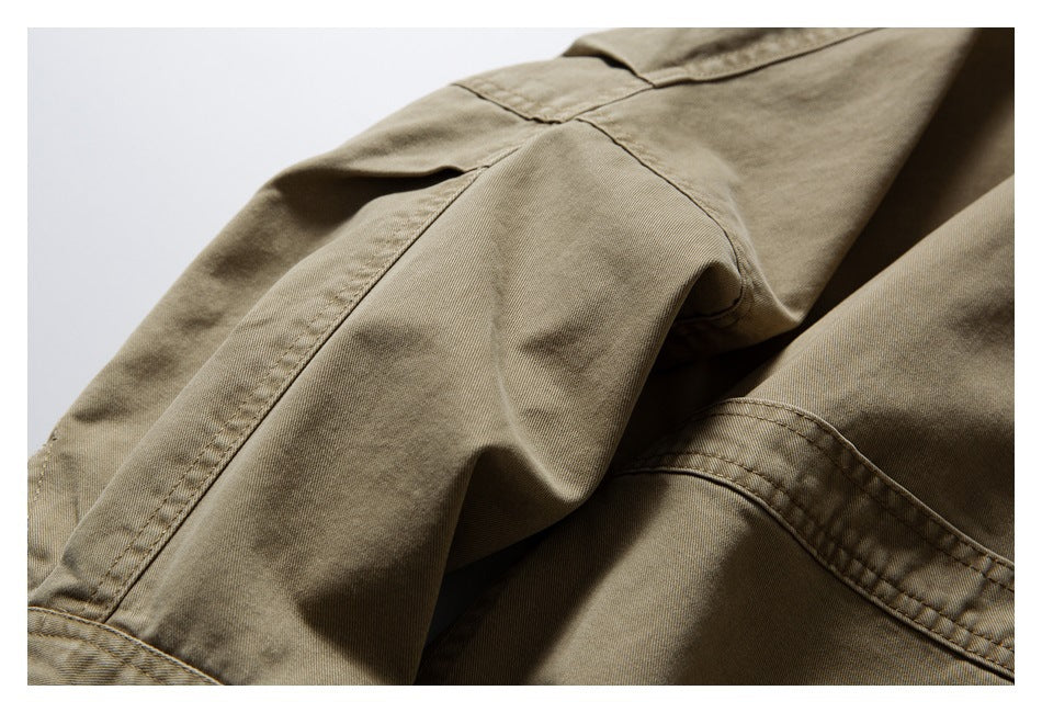 Close-up of stitched seams and folded fabric on a khaki garment.