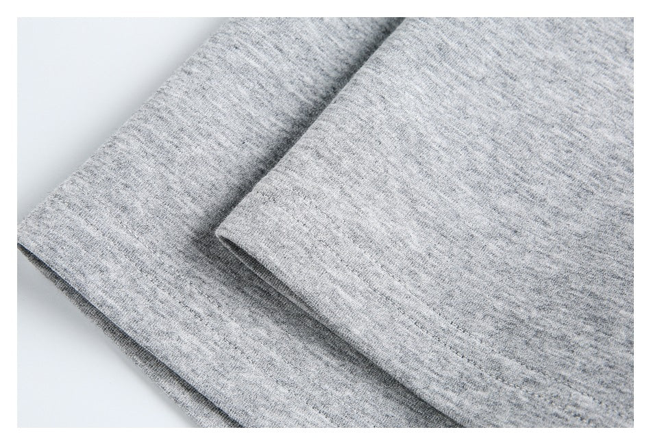 Close-up of a light gray heathered garment hem with a stitched edge.