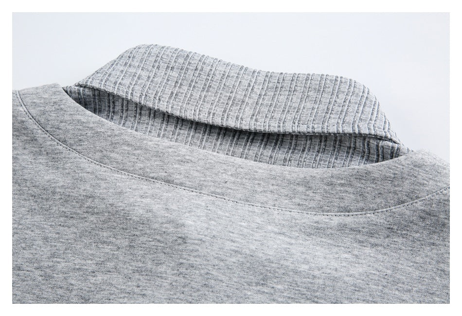 Close-up of a gray heathered garment neckline with a ribbed collar.