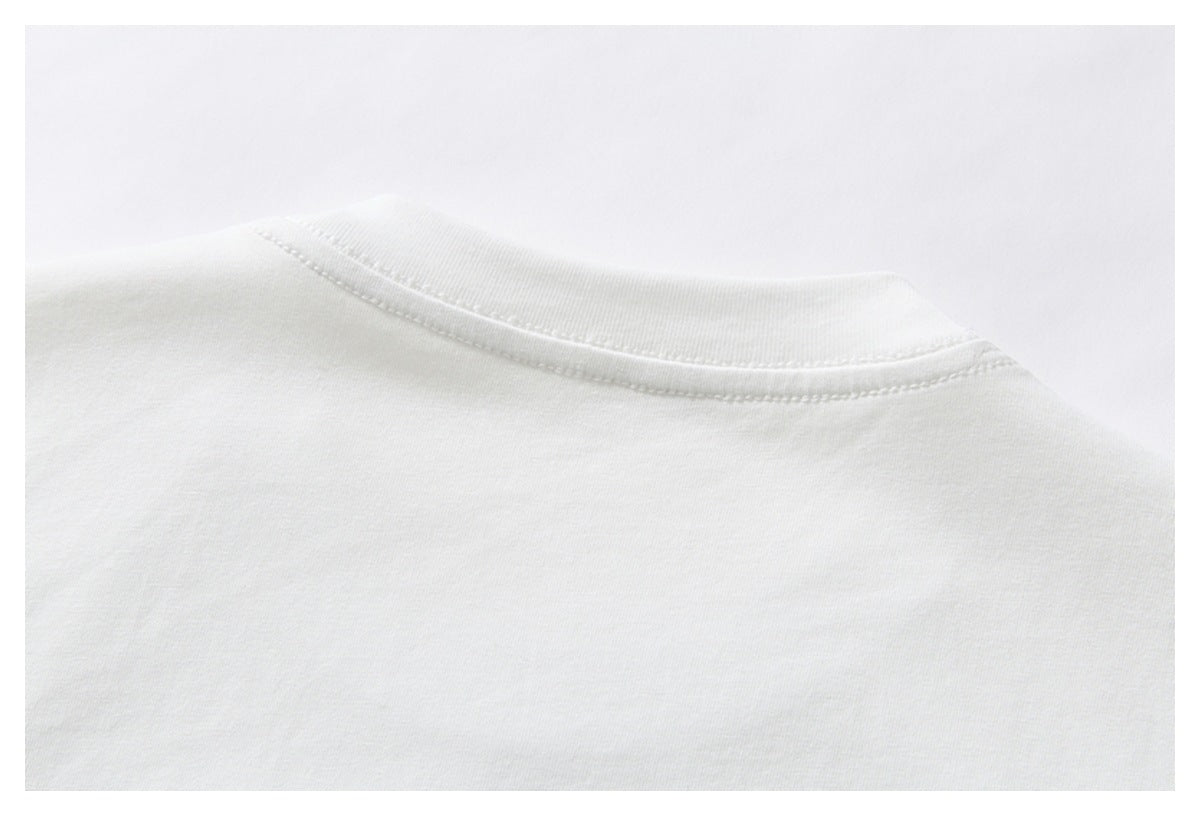 Close-up of the white shirt's crew neckline and collar seam.