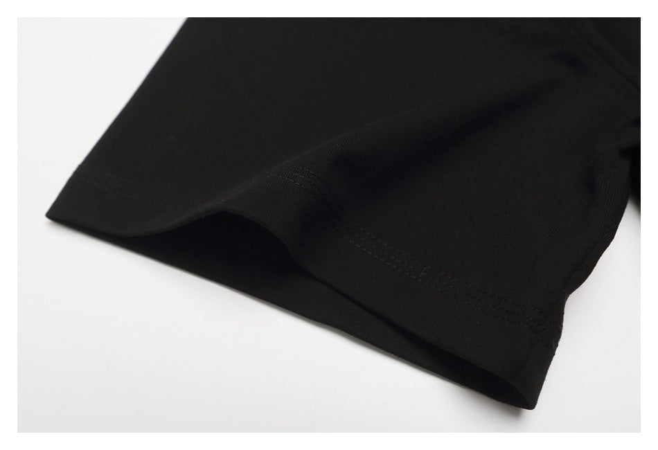 Close-up of the black T-shirt's folded bottom hem and parallel stitching.