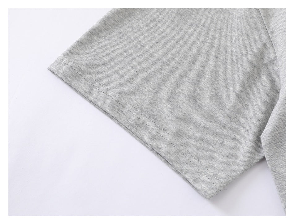 Close-up of a light gray T-shirt sleeve and stitched hem on a white background.