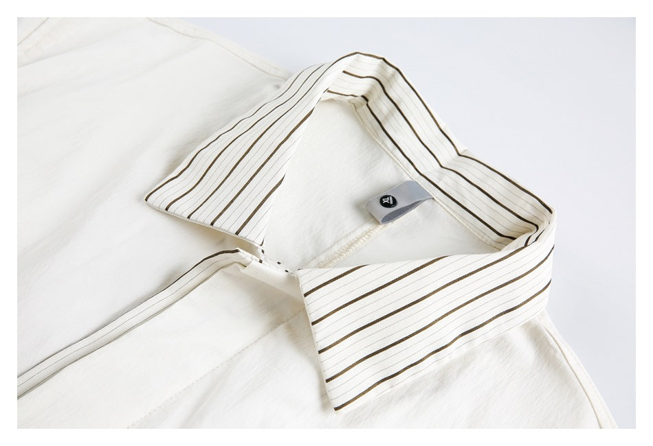 Close-up of the striped collar and neckline on a white short-sleeve shirt.