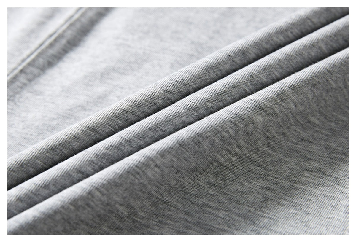 Close-up of folded heather gray T-shirt fabric showing its knit texture.