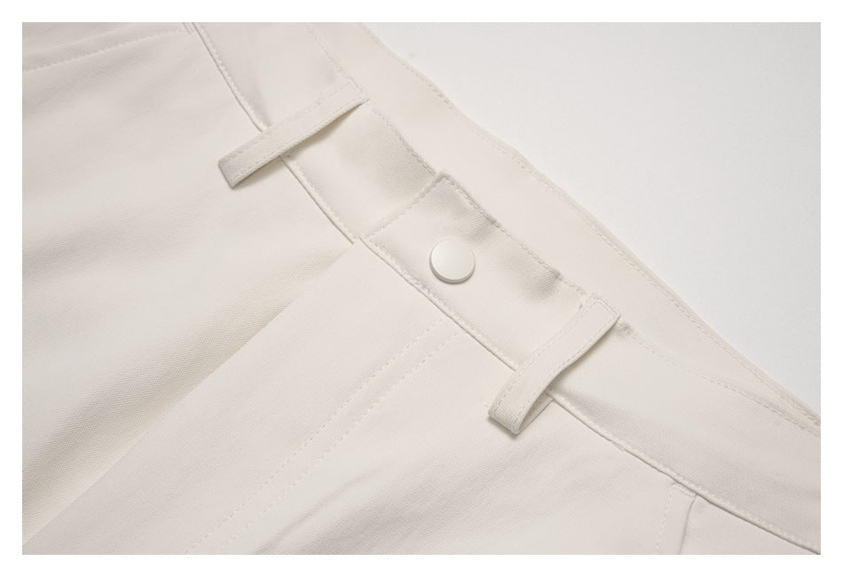 Close-up of the ivory waistband button and belt loops.