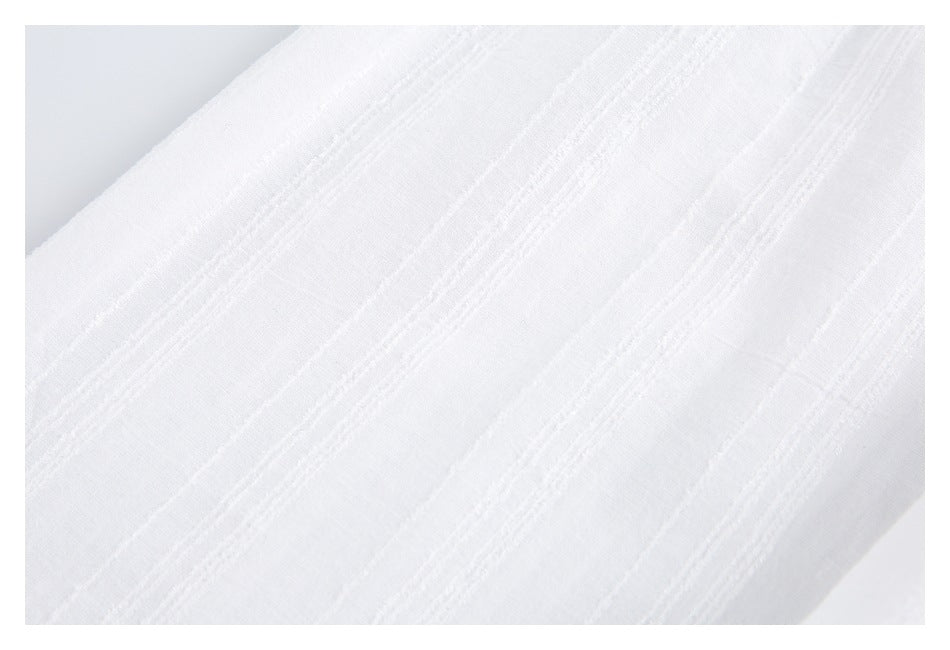 Close-up of white fabric showing raised stripe detailing.