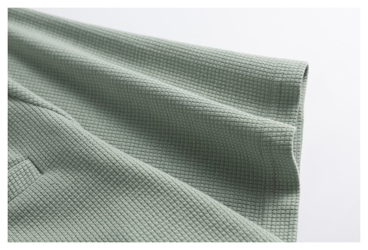 Close-up of the sage green textured top's sleeve and cuff.