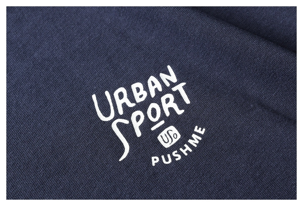 Close-up of navy knit fabric with a white printed “URBAN SPORT” graphic and smaller lettering.