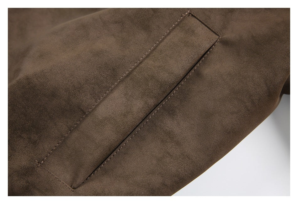 Close-up of a stitched pocket opening on the brown jacket.