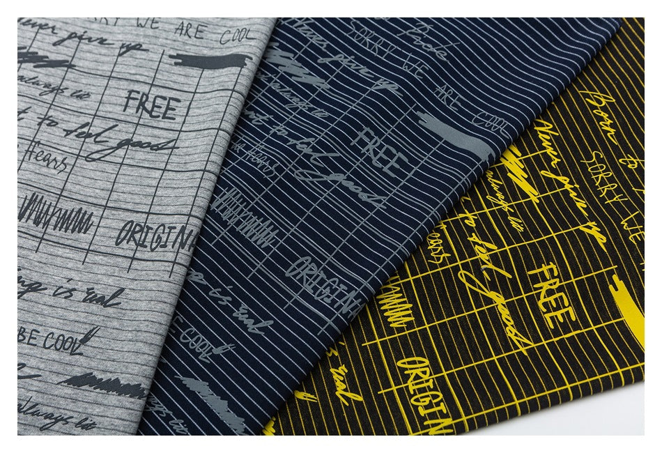 Three fabric colorways with fine stripes and printed English words in gray, navy, and black with yellow.