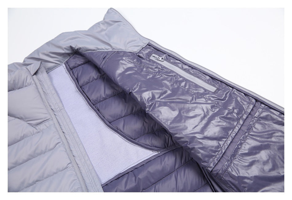 Open light gray padded jacket showing its darker quilted lining and an inner zippered pocket.