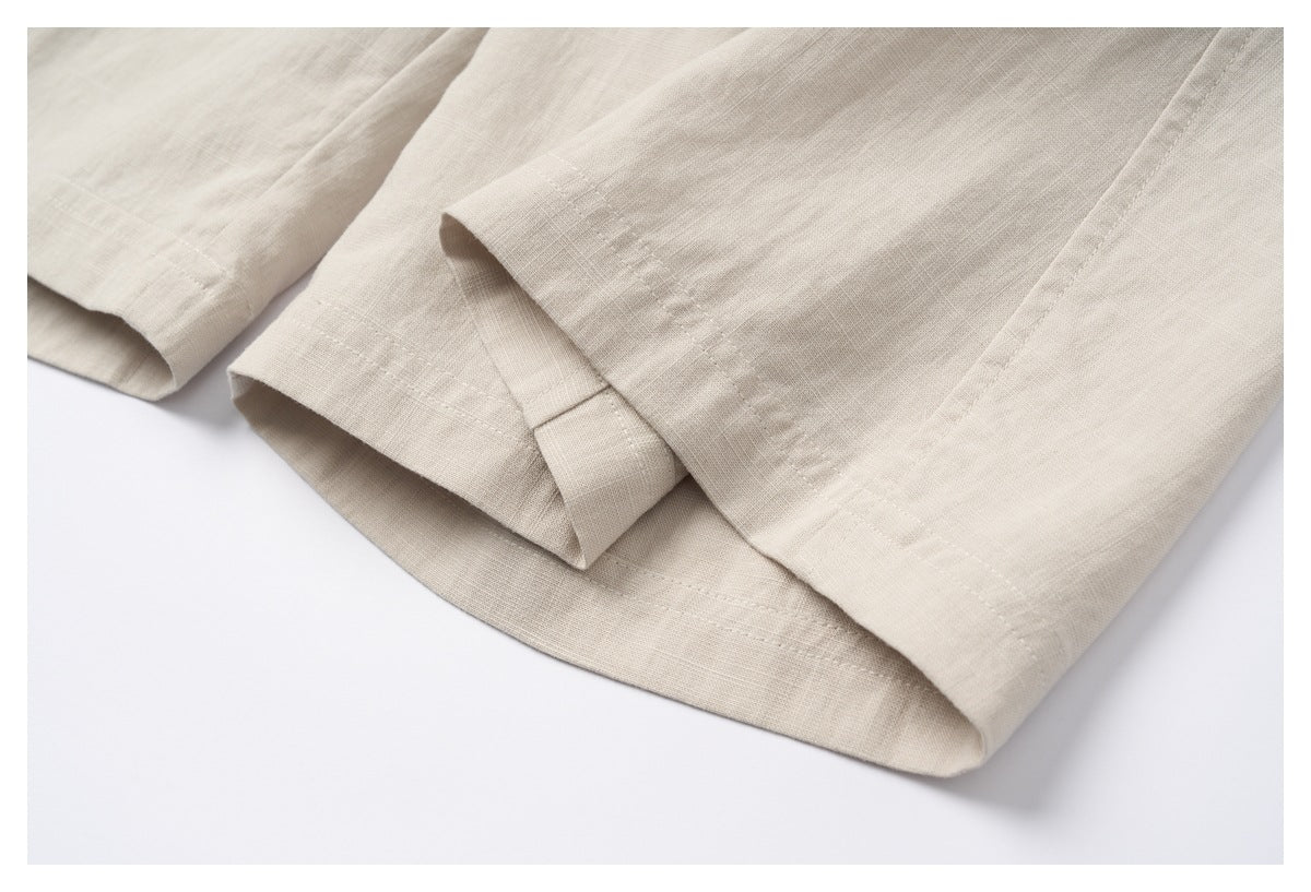 Close-up of the cream garment's hem, with a folded section showing the inside stitching.