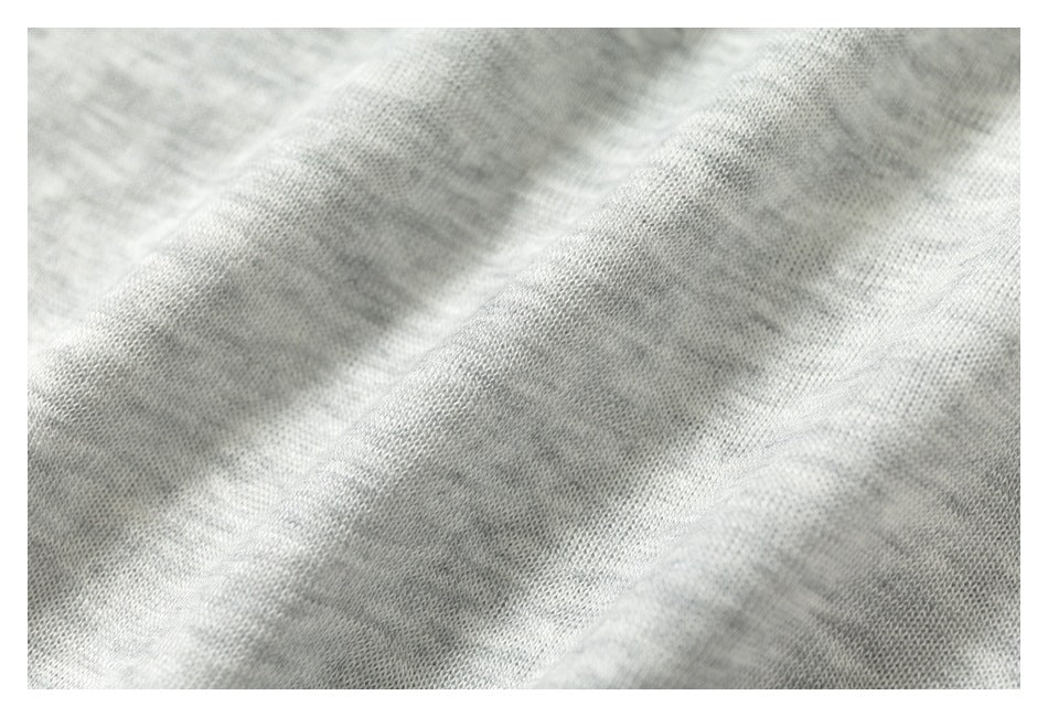 Close-up of light gray knit fabric with a fine, soft-looking texture.