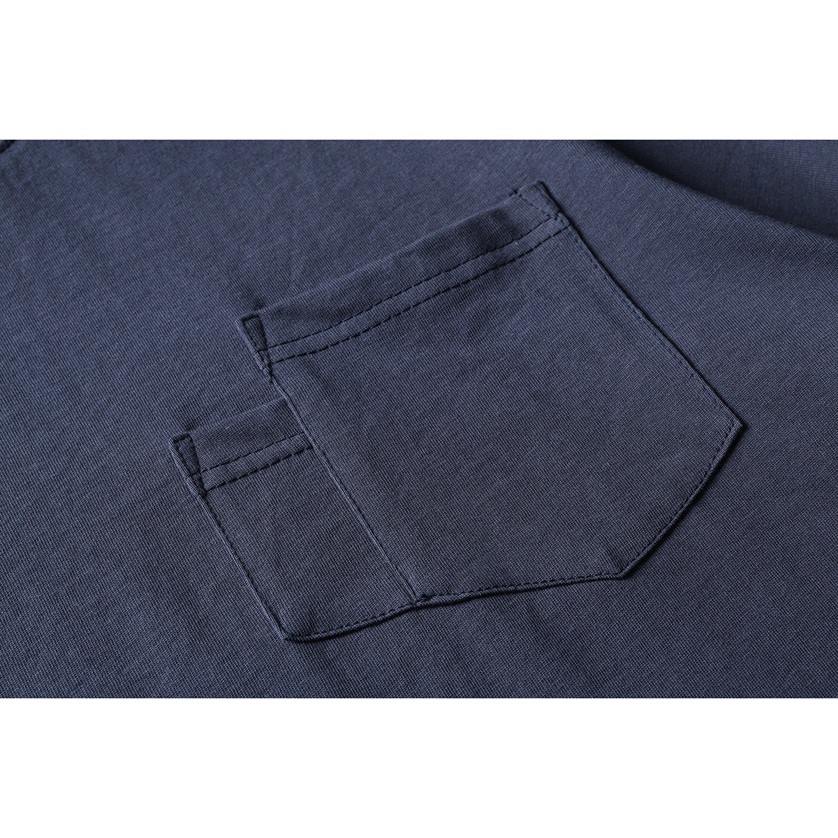 Close-up of a dark navy T-shirt's stitched chest pocket.