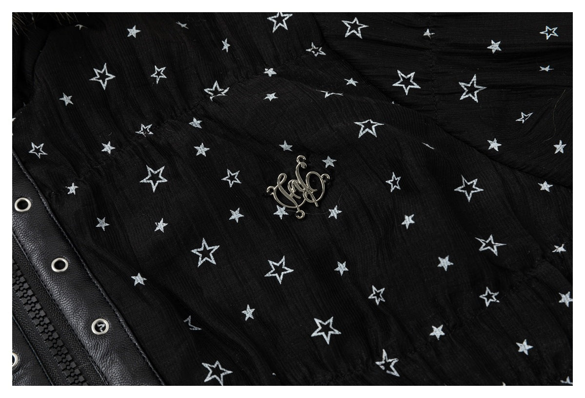 Close-up of the jacket's white star print, decorative chest emblem, and black zipper placket.