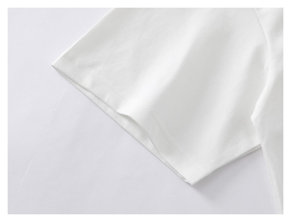 Close-up of a white T-shirt sleeve and stitched hem.