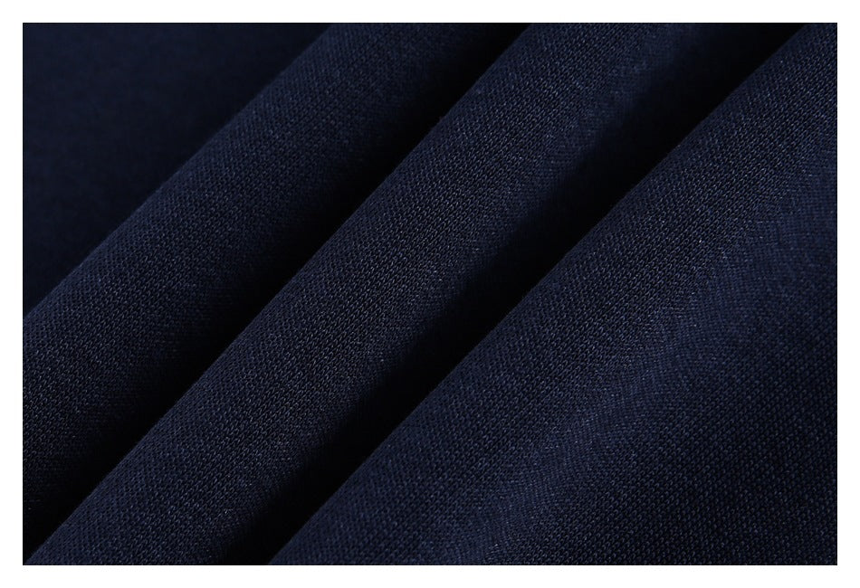 Close-up of dark navy knit fabric draped in soft folds.