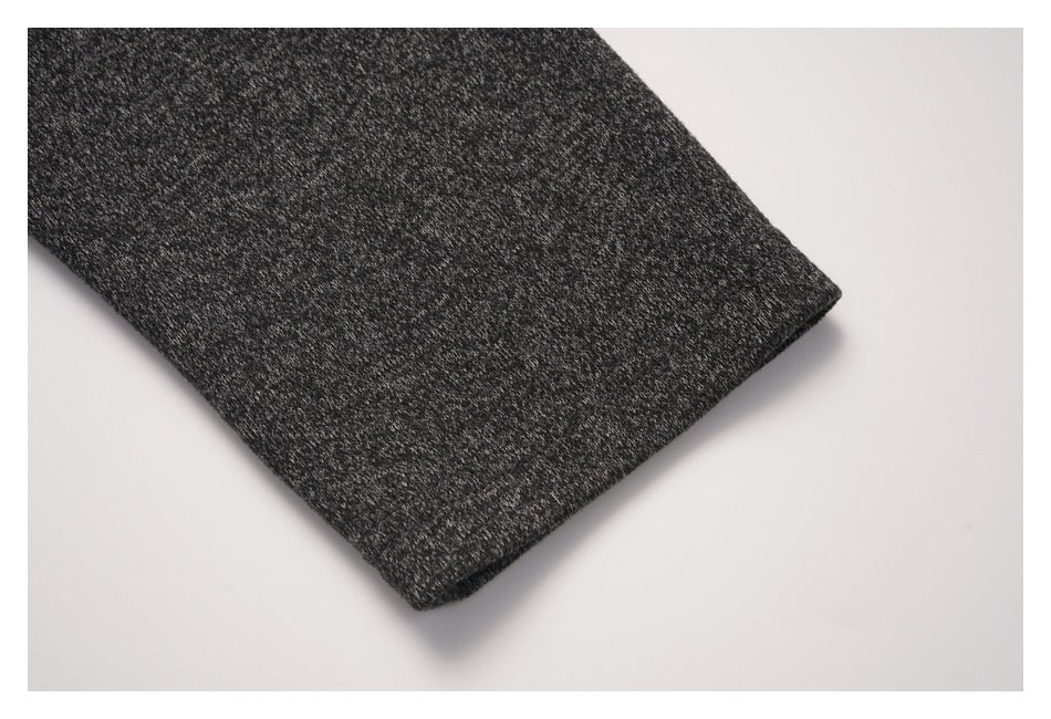 Close-up of the charcoal heather shirt sleeve and its finished edge.