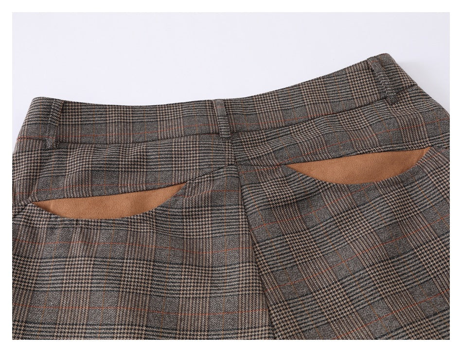 Back waist detail of brown-gray plaid trousers with belt loops and two welt pockets.
