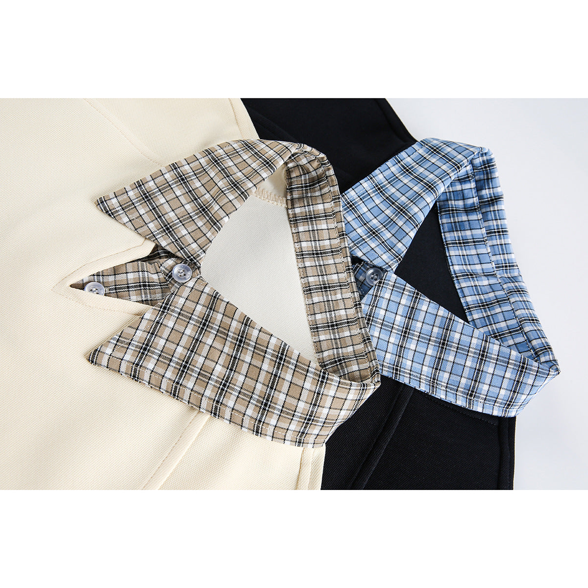Close-up of cream and black shirts with tan and blue plaid collars and buttons.